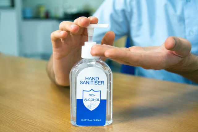 man using hand sanitiser
